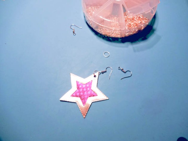 Punch a small hole and add a large jump ring and an earring hook