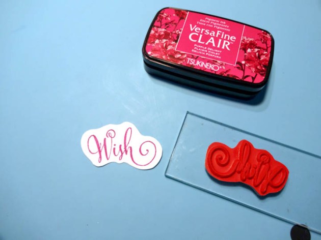 Stamp the "Wish" sentiment stamp with VersaFine Clair Purple Delight ink