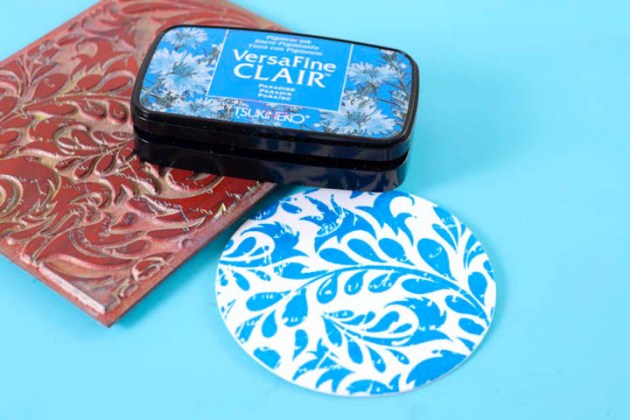 Stamp a background image onto white cardstock using VersaFine Clair in Paradise
