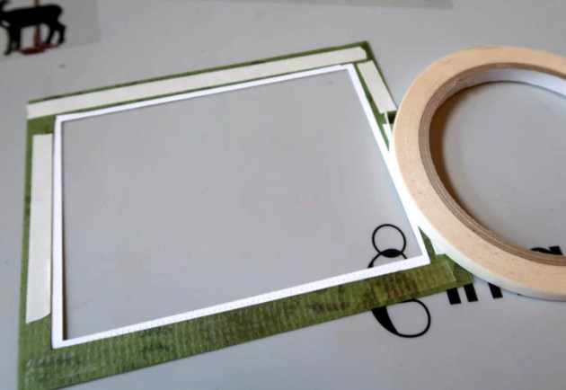  Use Tear It Tape to affix the front acetate panel to the card frame.